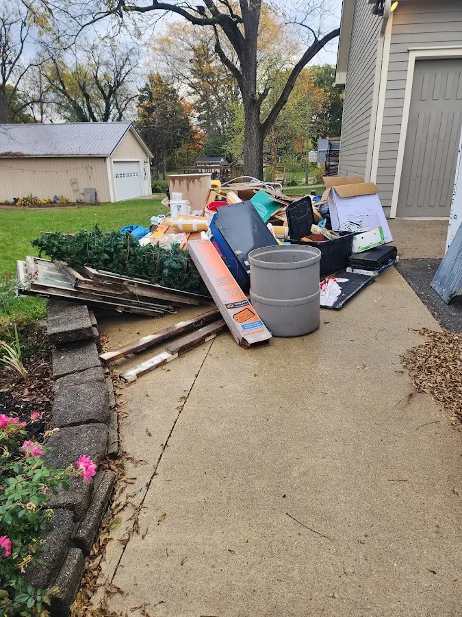 Dumpster being loaded with debris for Roofing Dumpster Rental in Waite Park